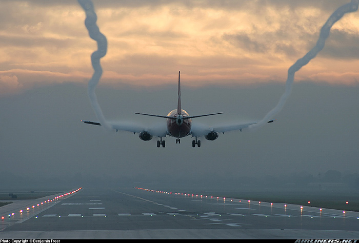 An aerodynamic contrail on a landing jet